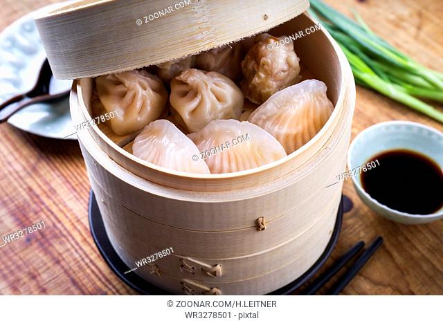 Traditional Chinese Dim Sum as close-up on Bamboo Steamer
