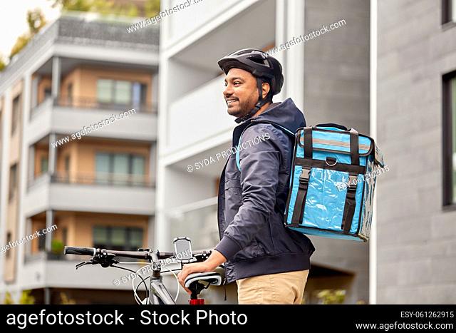 food delivery man with bag and bicycle in city