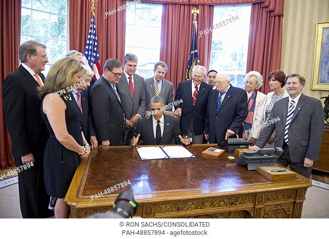 United States President Barack Obama signs H.R. 685, the ""American Fighter Aces Congressional Gold Medal Act, "" which provides for the award of a single...
