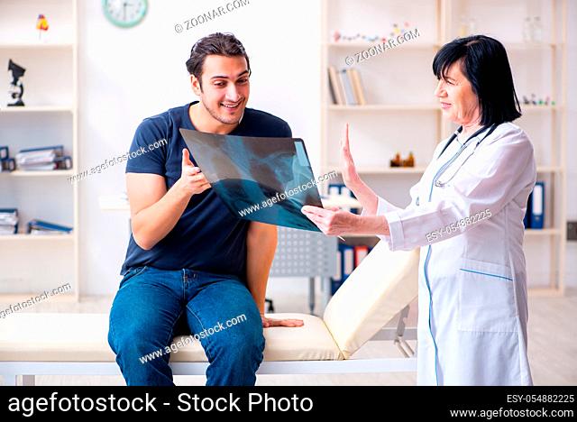 Young male patient visiting aged female doctor