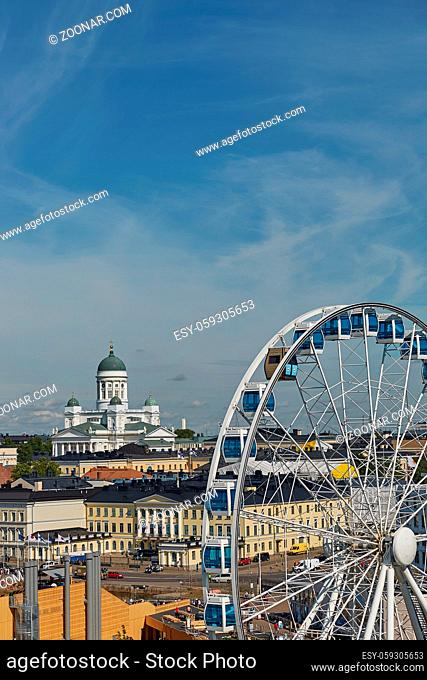 Ferris wheel and Cathedral of the Diocese of Helsinki, finnish Evangelical Lutheran church, located in the neighborhood of Kruununhaka in Helsinki, Finland