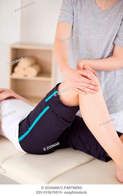 Portrait of a sportswoman having a knee massage