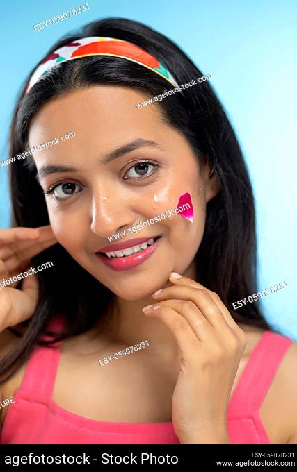 Portrait of beautiful woman Smiling with Red Rose Leave on her face