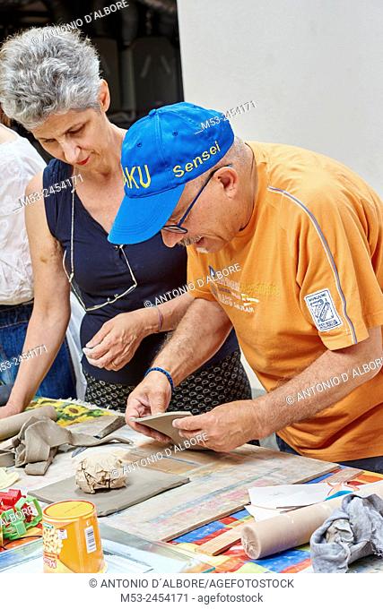 Amateur artists while modeling clay to obtain raku ceramics