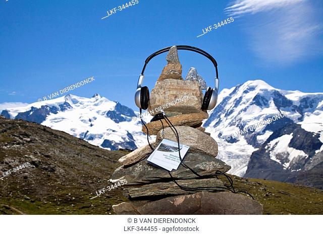 Headphones on a cairn myclimate audio trail, Monte Rosa and Liskamm in background, Zermatt, Canton of Valais, Switzerland