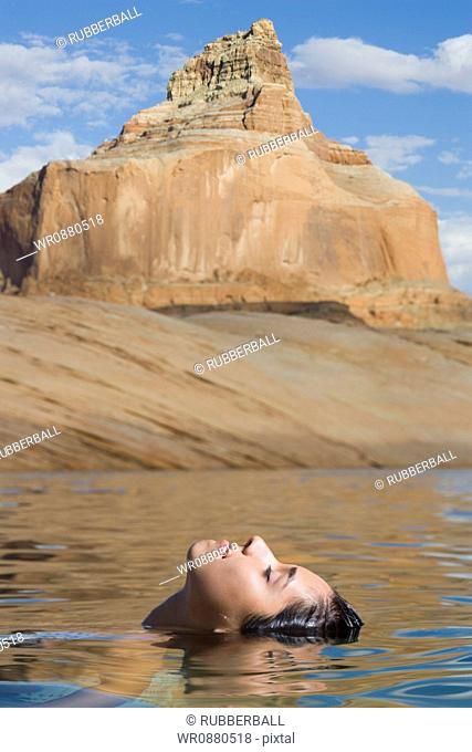 Profile of a young woman swimming