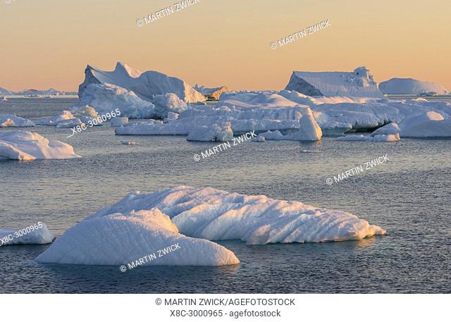 Icebergs in the Disko Bay. The Inuit village Oqaatsut (once called Rodebay) located in the Disko Bay. America, North America, Greenland, Denmark
