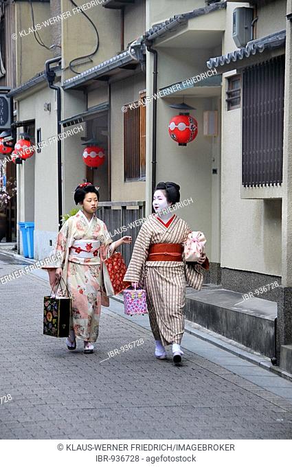 Maikos, Geisha apprentices, in the Gion quarter in Kyoto walking to Odori performance, Japan, Asia