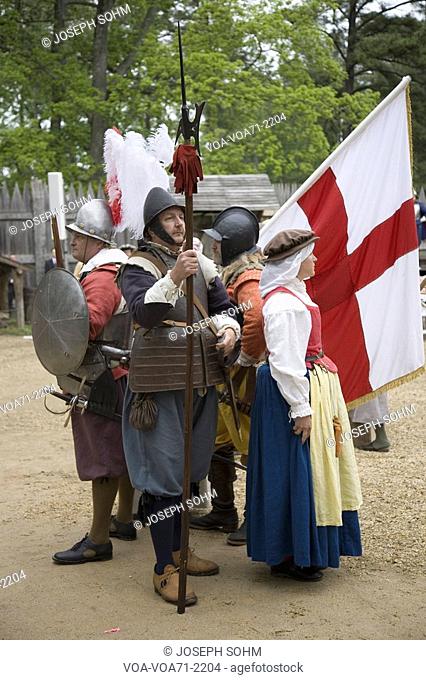 English settler reenactors holding English flag bearing the Cross of St. George as part of the 400th anniversary of the Jamestown Colony, Virginia