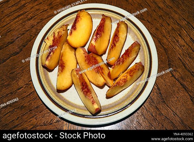 Fresh peach slices on a plate