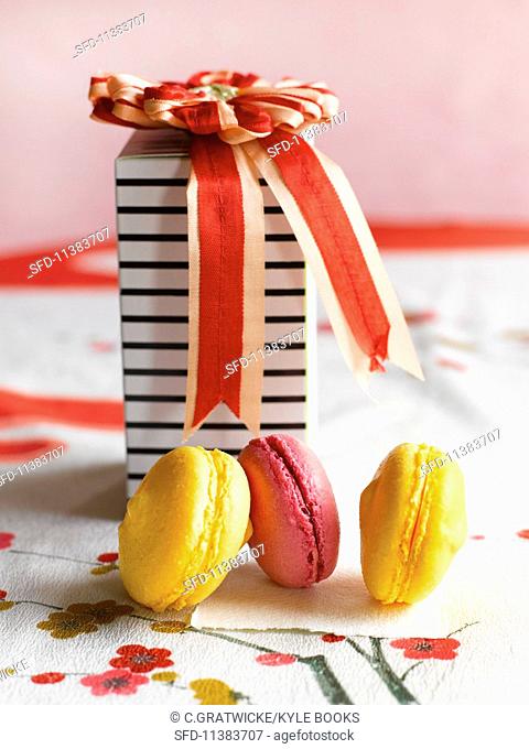 Macaroons in front of a decorative gift box