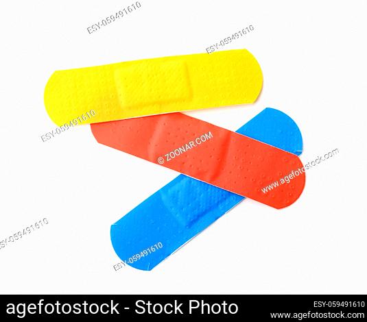 Top view of colorful adhesive bandage patches isolated on white