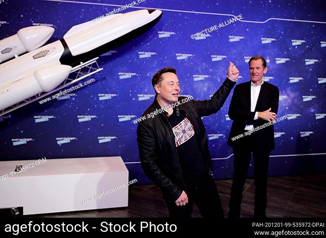 01 December 2020, Berlin: Elon Musk (l), head of the space company SpaceX and Tesla CEO, and Mathias Döpfner, CEO of Axel Springer SE