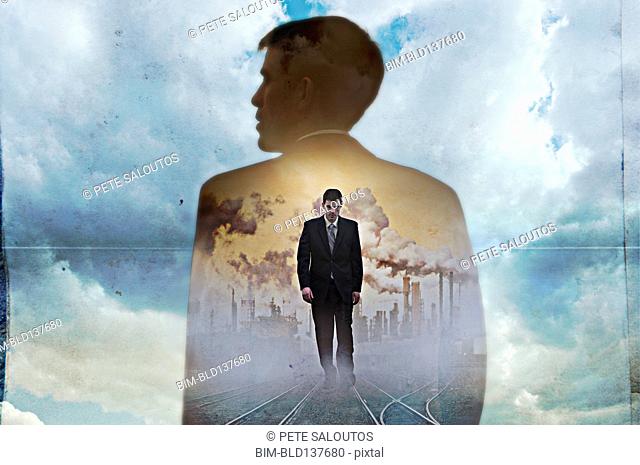 Double exposure of businessman in clouds