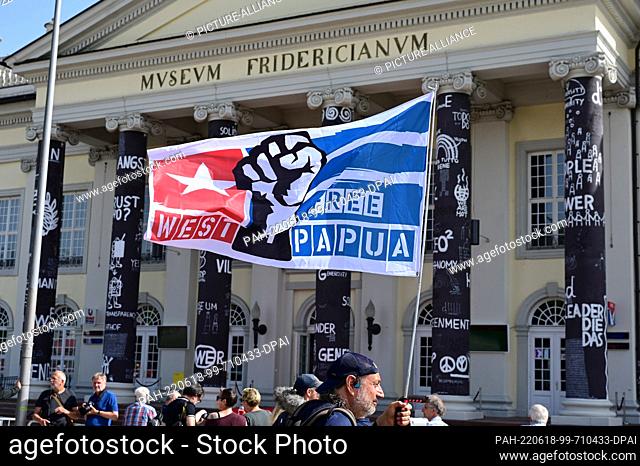 18 June 2022, Hessen, Kassel: ""Free West Papua"" is written on a flag held aloft by a man at the opening of documenta fifteen in front of the Fridericianum