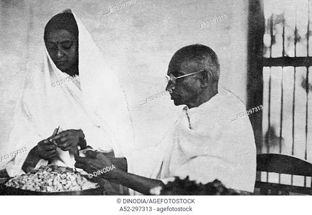 Gandhi cutting vegetables in the Ashram Canteen. 1945