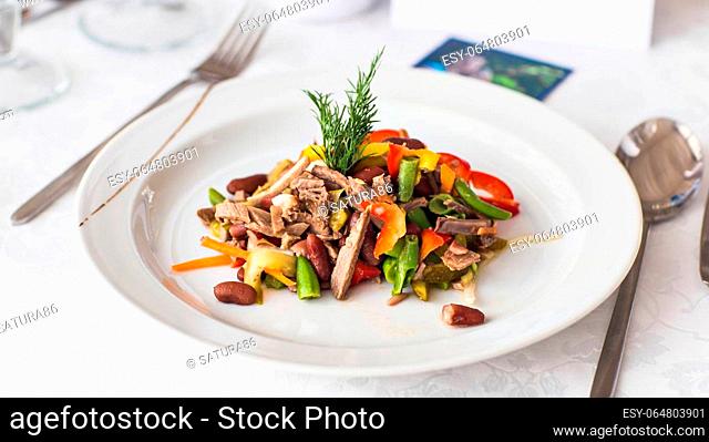 delicious meat salad with meat on white plate