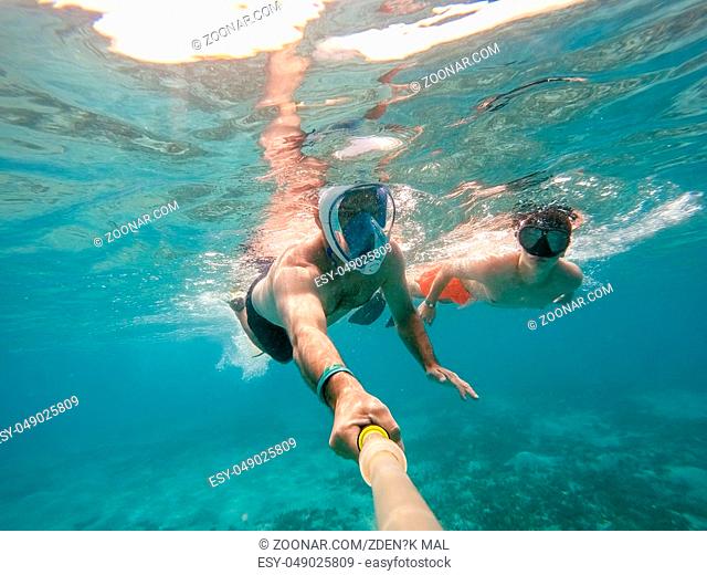 father and son snorkel in underwater exotic tropics paradise with fish and coral reef, beautiful view of tropical sea. Marsa alam, Egypt