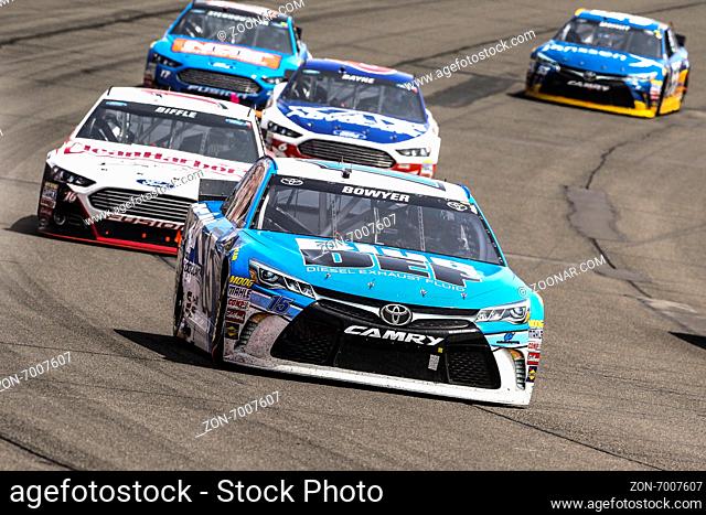 Fontana, CA - Mar 22, 2015: Clint Bowyer (15) brings his race car through the turns during the race at the Auto Club Speedway in Fontana, CA