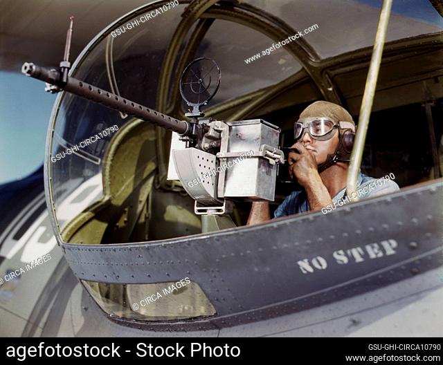 Jesse Rhodes Waller, Aviation Ordnance Mate, Third Class, trying out 30-calibre machine gun he just installed on Navy Plane, Naval Air Base, Corpus Christi