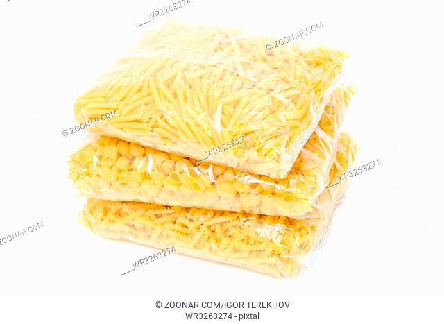 three packets of pasta on a white background