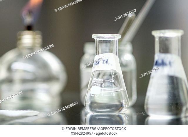 Flasks are shown marked with tape and filled with liquid in a laboratory at the Reserva Forestal Los Santos in San Marcos, Costa Rica