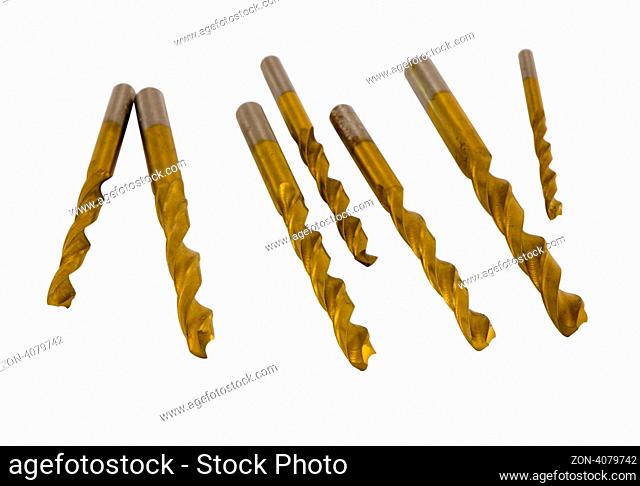 Various size golden drill bits isolated on white background