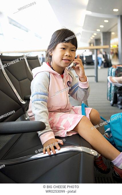 Girl with mobile phone at airport