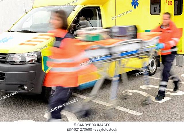 Running blurry paramedics team with stretcher