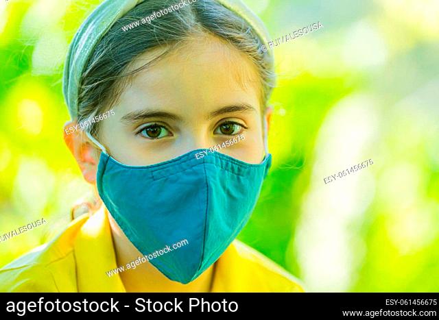Little girl with mask against corona virus covid outdoor