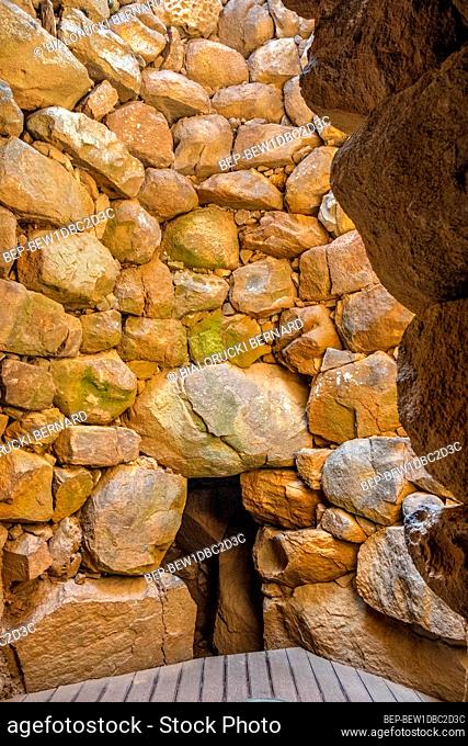 Arzachena, Sardinia / Italy - 2019/07/19: Archeological ruins of Nuragic complex La Prisgiona - Nuraghe La Prisgiona - with interior of stone tower of Neolithic...
