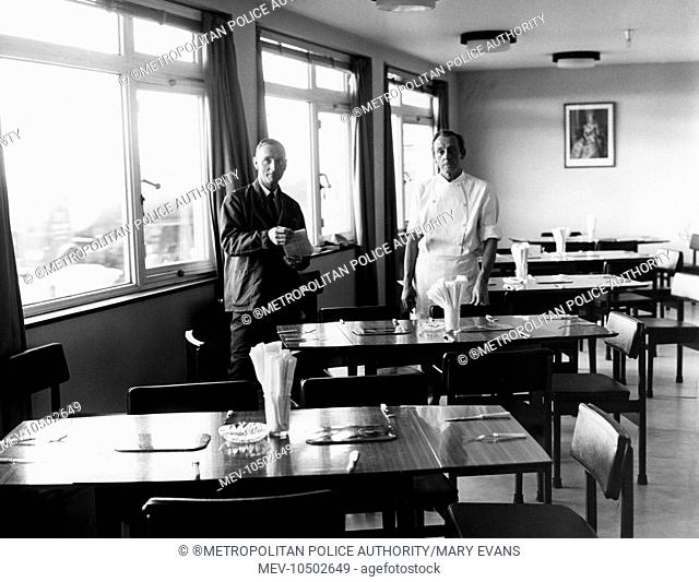Two of the catering staff in the dining room of the Convalescent Police Seaside Home at 205 Kingsway, Hove, East Sussex. The are the head chef and a steward...