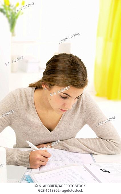 teenage girl doing her homework at home