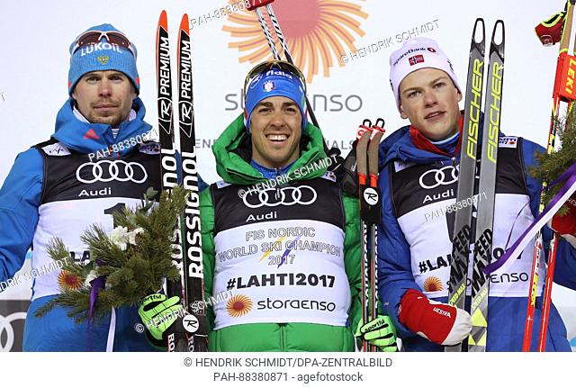 Second-placed Russian athlete Sergej Ustjugow (l-r), Italian winner Federico Pellegrino and third-placed Norwegian athlete Johannes Hösflot Kläbo celebrate...