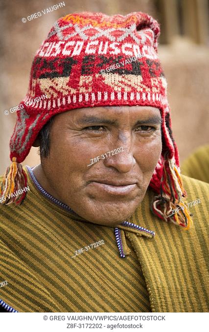Quechua man of Misminay village wearing traditional woven poncho and knitted ch'ullu hat; Sacred Valley, Peru