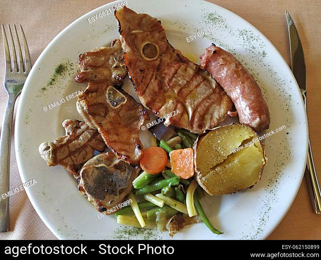 Grilled meat lamb, sausage and veggies at a restaurant. Lleida, Catalonia, Spain