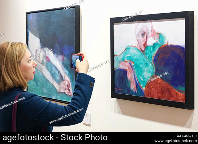 RUSSIA, MOSCOW - NOVEMBER 11, 2023: A visitor takes a photograph of ""Untitled"" by Alisher Kushakov at the 6th international interactive festival of...