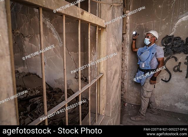18 July 2022, Iraq, Mosul: A member of the Tetra Tech company combs a building during a mine clearance operation to locate and clear landmines and explosive...