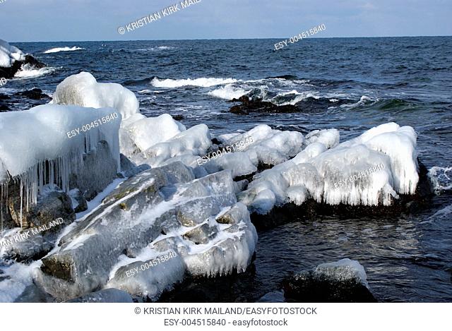 Ice on rocks by the sea. Bornholm, Island in the Baltic Sea