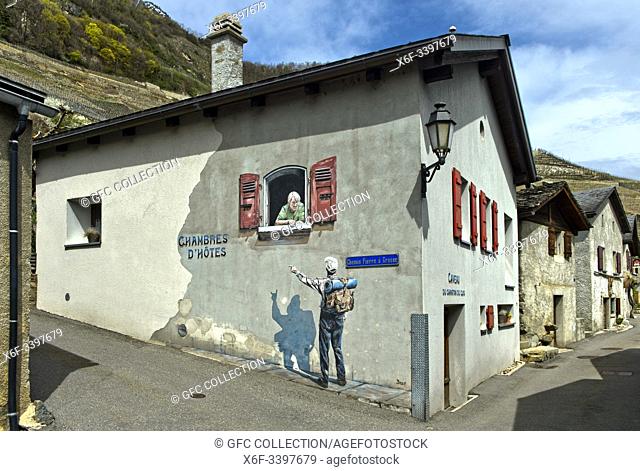 Hiker looking for acomodation speaks to a landlady, Trompe-lâ. . œil painting at a house, Branson, Valais, Switzerland