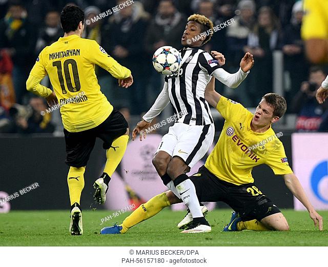 Dortmund's Henrikh Mkhitaryan (L) and Matthias Ginter vie for the ball with Kingsley Coman (M) during the UEFA Champions League Round of 16