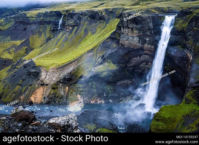 dramatic landscape of epic haifoss waterfall in landmannalaugar canyon, iceland