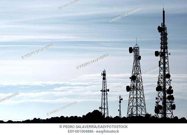 silhouette of a group of telecommunication towers, La Muela, Saragossa province, Aragon, Spain