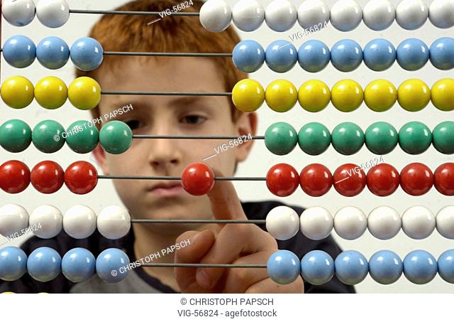 Left-handed boy calculating with an abacus. - BONN, GERMANY, 15/04/2004