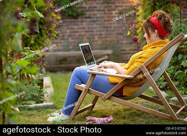 Woman working at laptop in garden