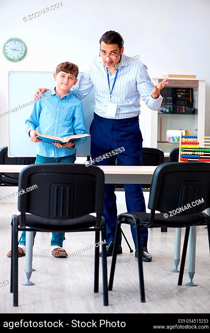 The young father helping his son to prepare for exam