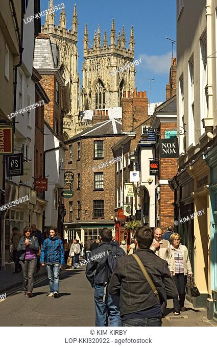 England, North Yorkshire, York, Visitors and shoppers in Low Petergate, a traffic free street full of shops and restaurants leading to York Minster