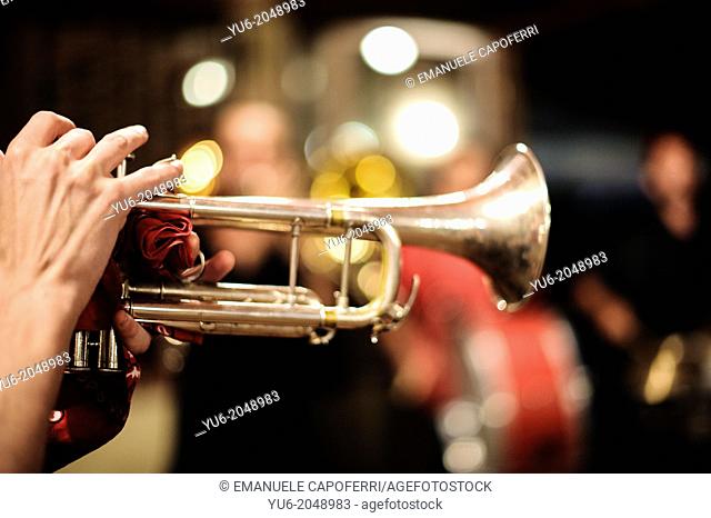 The hands of a musician as he plays the trumpet