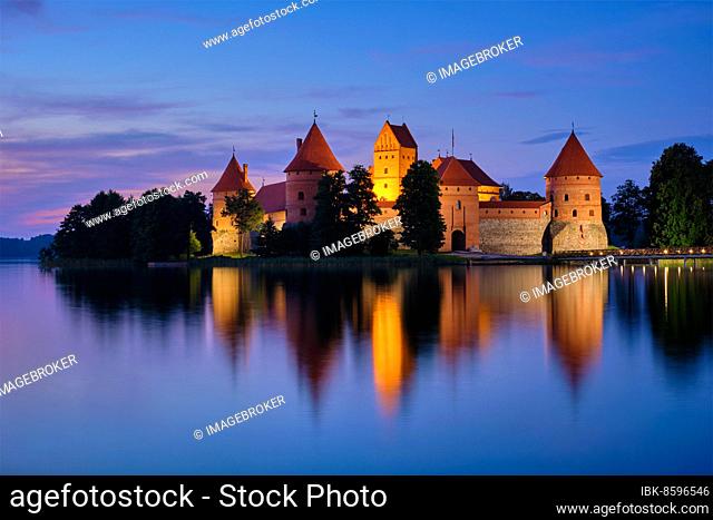 Night view of Trakai Island Castle in lake Galve illuminated in the evening, Lithuania, Europe