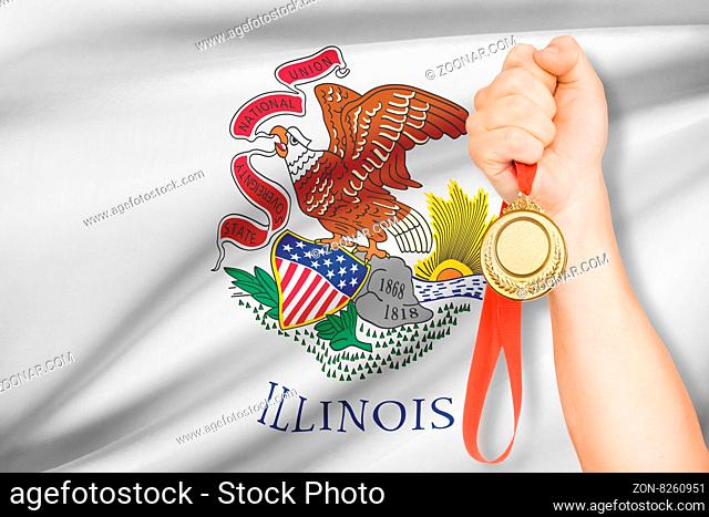 Sportsman holding gold medal with State of Illinois flag on background. Part of a series